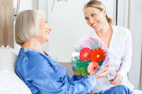 elderly woman holding a bouquet with her daughter